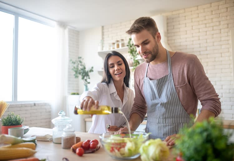 Couple cooking together in a kitchen