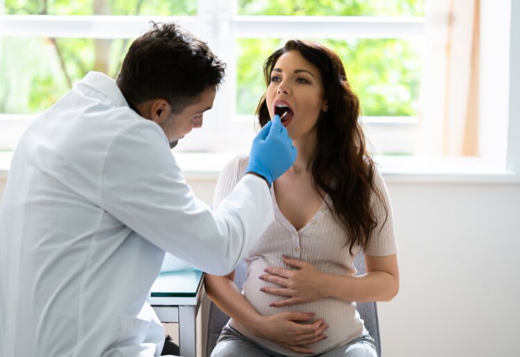 A women taking a DNA cheek swab test during pregnancy. 