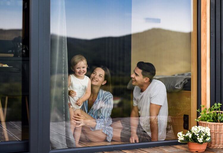 A family looking out of their window.
