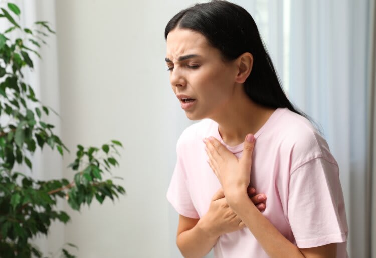 A woman experiencing shortness of breath due to anxiety. 