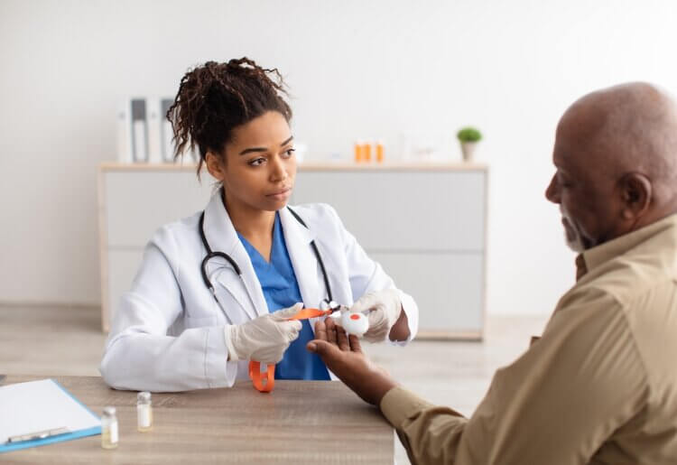 A doctor and patient sitting at a table discussing medical alerts.