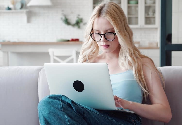 Woman working on a laptop.