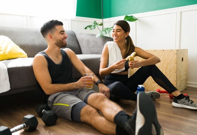 Aa man and a woman enjoying a pre-workout snack.