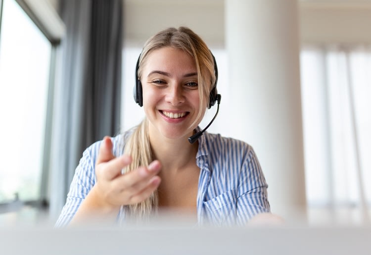 Smiling receptionist wearing headset.