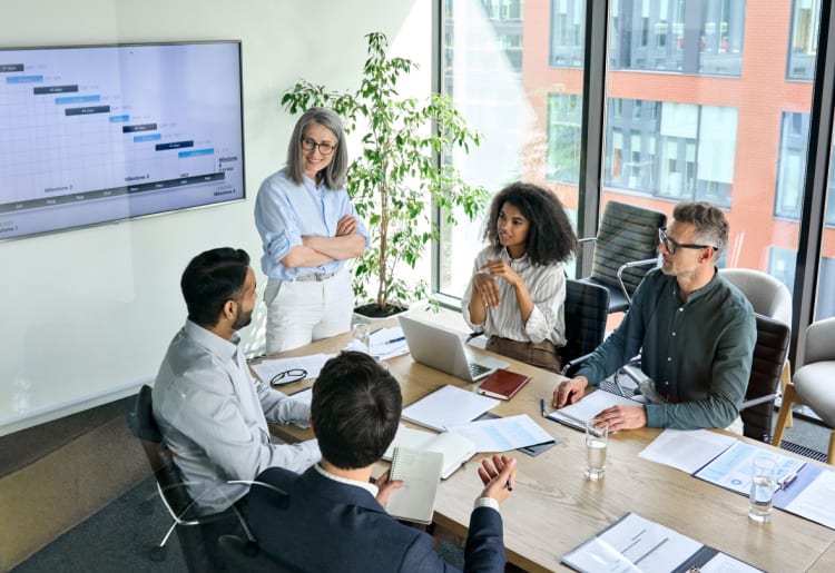 A project management team sitting around a conference table.
