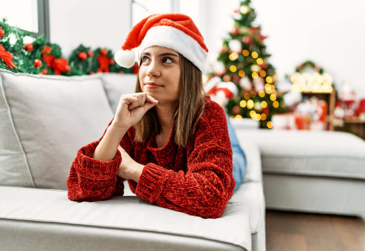 Woman thinking how to combat loneliness during the holidays.