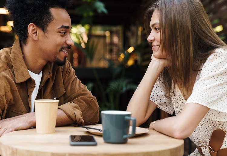 Couple staring at each other on a coffee date