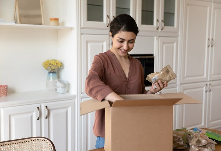 Woman unpacking box of food
