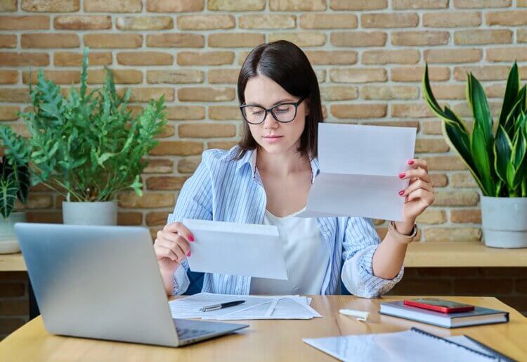A woman checking her taxes in her home office.