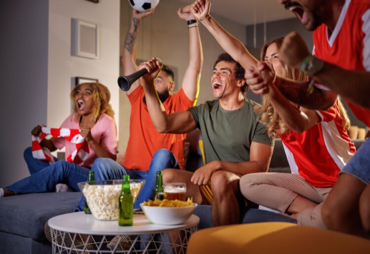 A group of friends streaming the EUFA Euro Qualifiers using a TV streaming service.  