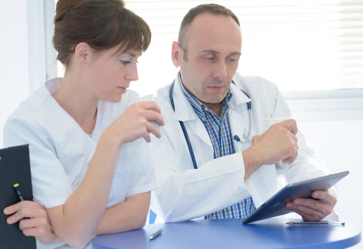 Two doctors examining test results.