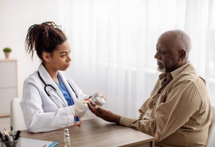 Doctor showing a patient a medical alert bracelet.