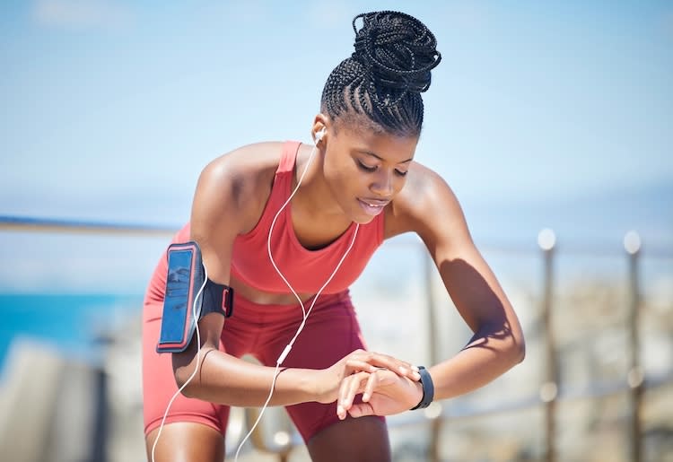  A runner checking her smart watch after using a blood test for athletic performance