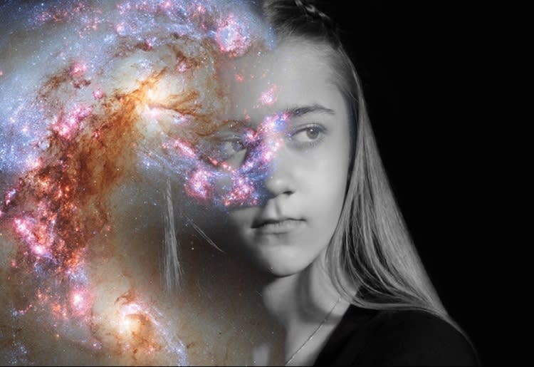 Black and white image of young girl with superimposed galaxy obscuring part of her face
