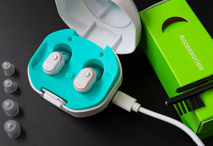 A rechargeable hearing aid in its charging case