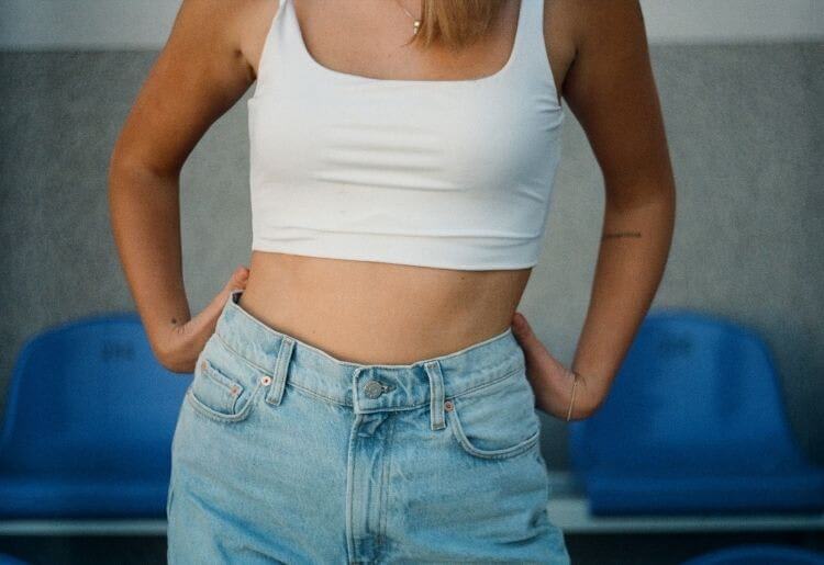 woman with flat belly in jeans