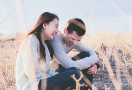 A man and woman laughing 
