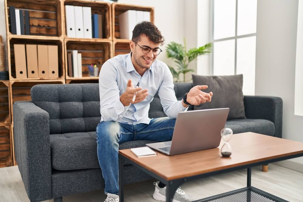 a laptop computer sitting on top of a wooden desk