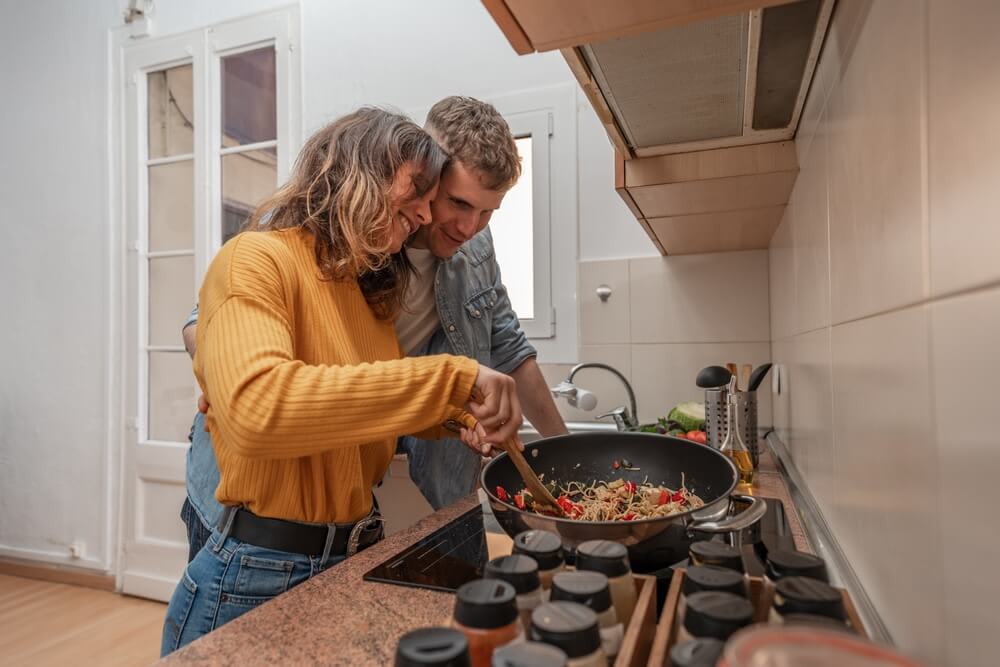 Young couple cooking together on a kitchen. Young couple cooking together on a kitchen.