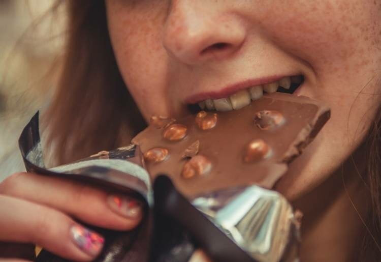 lady eating a chocolate bar 