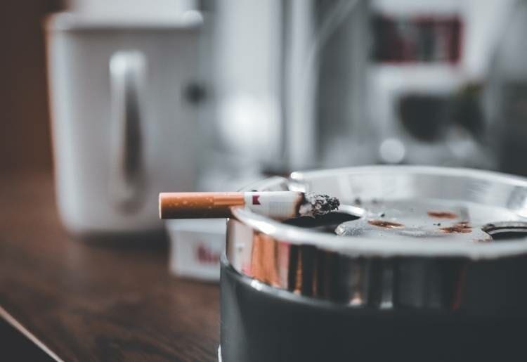 Cigarette resting on an ashtray 