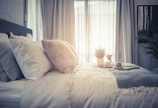 Best Mattresses Under $1,000 - Cozy Bed in Morning Light 