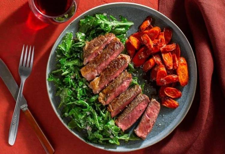 Black Angus rib-eyes with espresso-maple glazed carrots and arugula