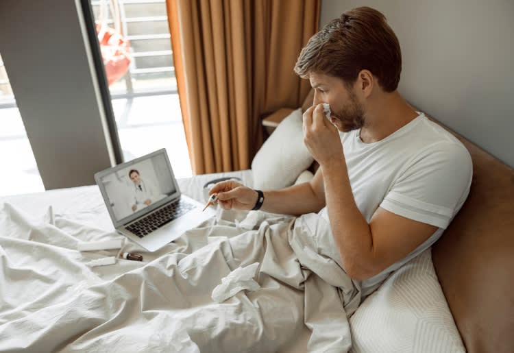 photo of a sick man talking with a doctor online