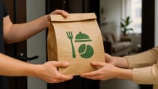 a couple of people holding a brown paper bag