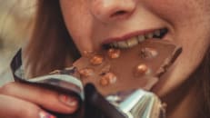 lady eating a chocolate bar 
