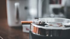 Cigarette resting on an ashtray 