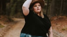 Woman in a forest wearing a hat