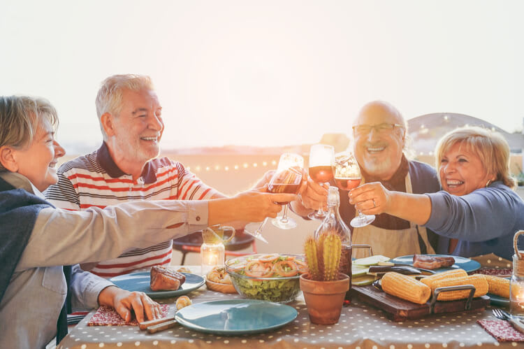 Senior friends enjoying dinner at home