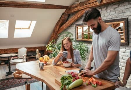 Man and women cooking food together